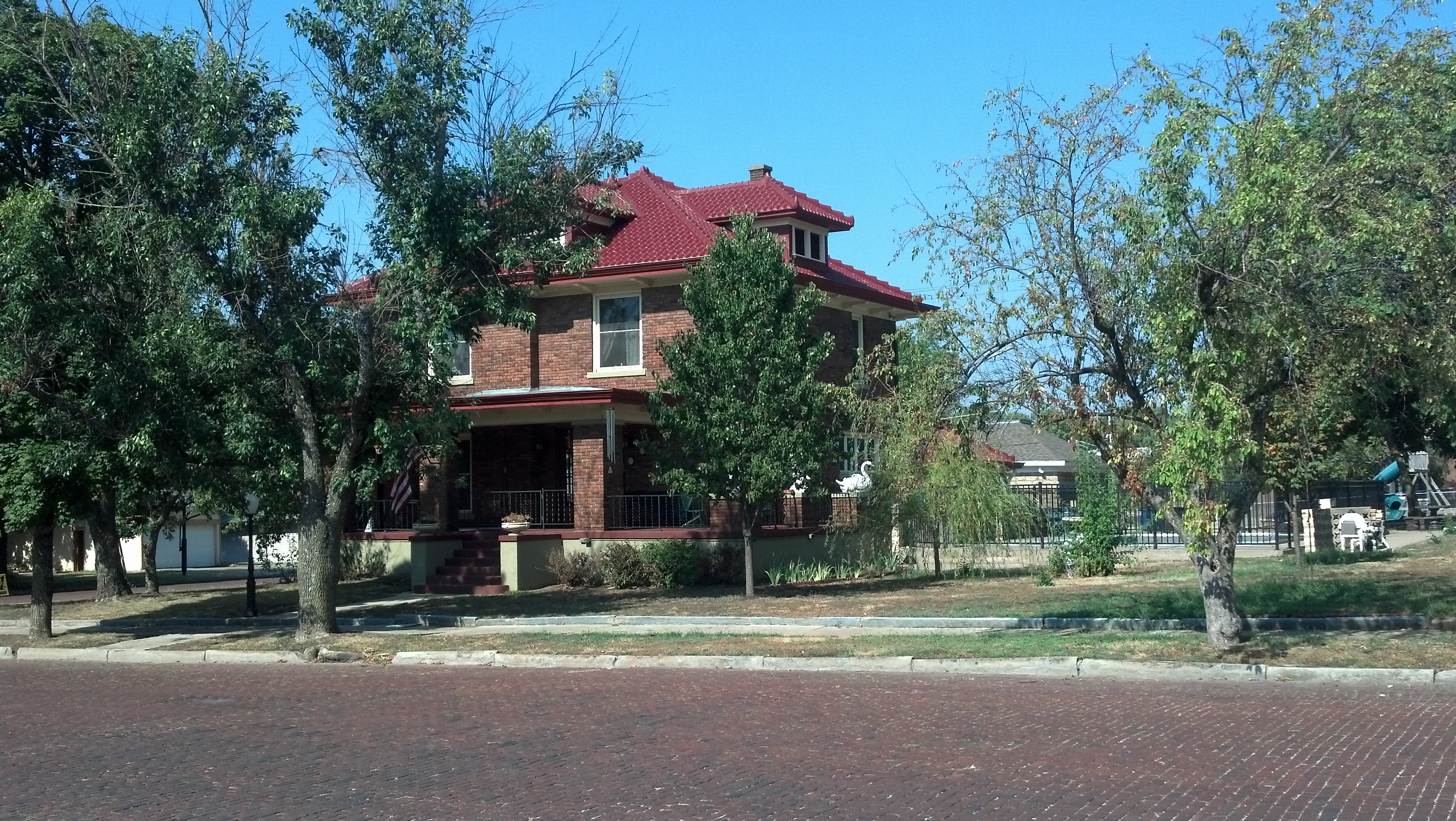 100-year-old historic metal roof coated in tile red - front view