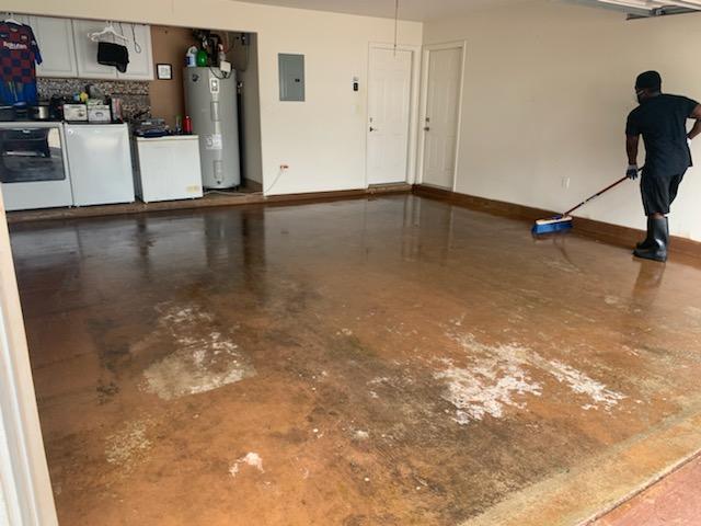 Badly worn, stained bare concrete garage floor before Armor Chip epoxy