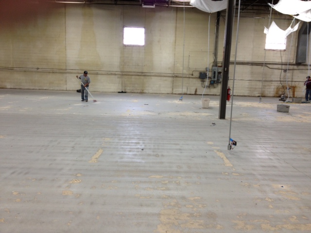Worn industrial concrete slab before refinishing